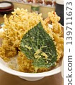 Golden crispy tempura shrimp sits atop rice 139711673