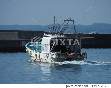 Small fishing boats leaving the harbor Small fishing boats leaving the harbor 139712126