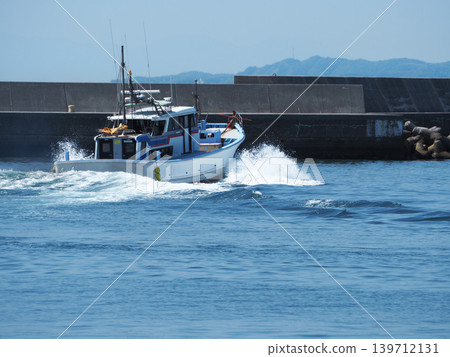 Small fishing boats leaving the harbor Small fishing boats leaving the harbor 139712131