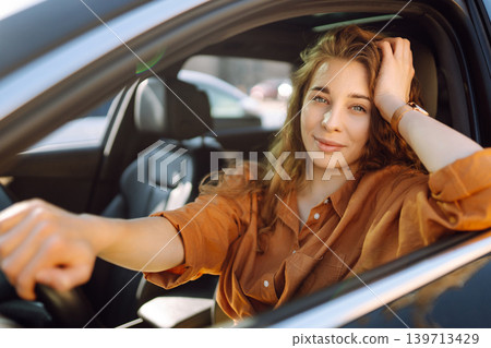 Emotional woman drives a car. The concept of fast movement, traveling by car. 139713429