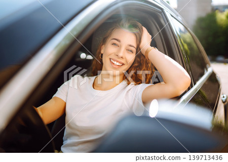 Emotional woman drives a car. The concept of fast movement, traveling by car. 139713436
