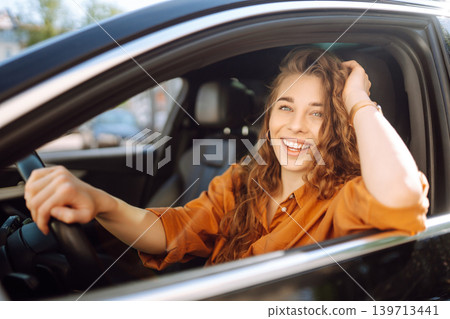 Emotional woman drives a car. The concept of fast movement, traveling by car. 139713441