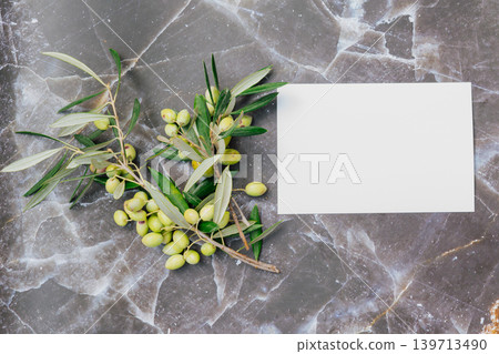 Fresh olive branch with green fruits on marble surface, blank white paper for copy space, Mediterranean organic food and premium wellness concept 139713490