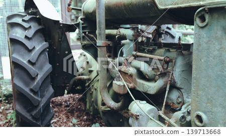 Vintage Rusty Tractor Behind Wooden Fence 139713668