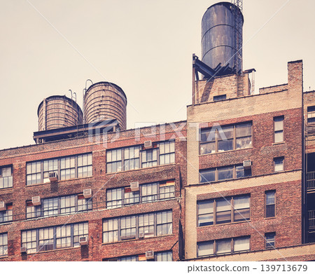 Water towers on a roof in downtown New York, color toning applied, USA. 139713679