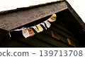 Colorful Buddhist prayer flags under the eave of a wooden building 139713708