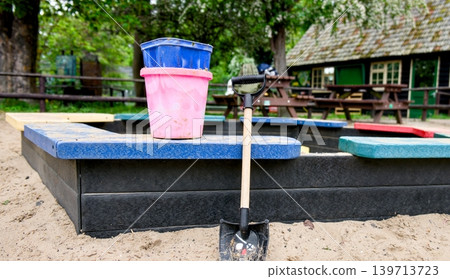 Toy Bucket and Shovel on Playground Sandbox Edge Toy Bucket and Shovel on Playground Sandbox Edge 139713723