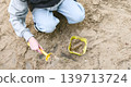 Child Playing with Shovel and Bucket in Sandbox 139713724