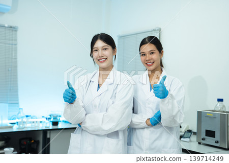 Two researchers in a modern laboratory, successful collaboration, scientific partnership, and innovation in medical research. Two researchers in a modern laboratory, successful collaboration, scientific partnership, and innovation in medical research. 139714249