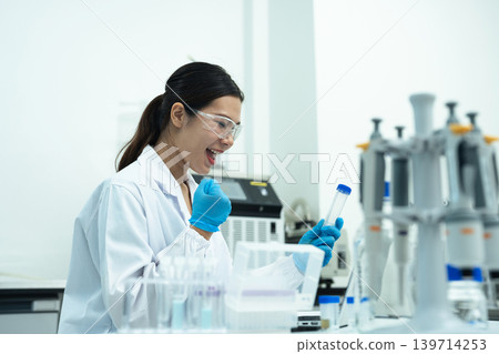 Asian female environmental scientists analyzing water quality samples with centrifuge and petri dish in laboratory. Asian female environmental scientists analyzing water quality samples with centrifuge and petri dish in laboratory. 139714253