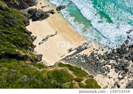 Aerial view of the rocky headland between Seven Mile Beach and Sharkies Beach in Forster NSW Australia. Drone photograph captures rugged coastal formations, turquoise ocean water Aerial view of the rocky headland between Seven Mile Beach and Sharkies Beach in Forster NSW Australia. Drone photograph captures rugged coastal formations, turquoise ocean water 139714354