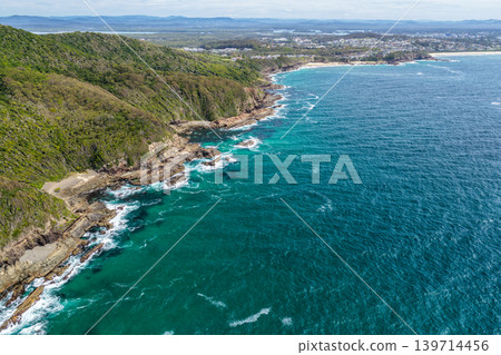 Aerial drone view over McBrides rockpool showing the natural rock formation along a rugged coastline. Ocean water surrounds the rockpool creating a scenic coastal landscape from an elevated Aerial drone view over McBrides rockpool showing the natural rock formation along a rugged coastline. Ocean water surrounds the rockpool creating a scenic coastal landscape from an elevated 139714456