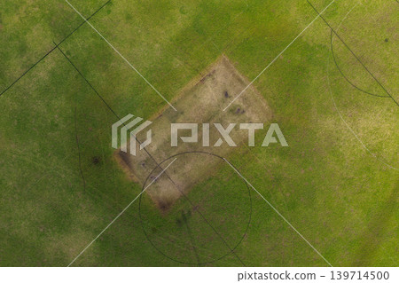 Aerial drone view directly above sports playing field at Maitland Park Sportsground in Maitland, New South Wales, Australia showing painted field markings on green grass surface. 139714500