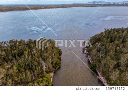 Aerial drone view looking over a water inlet opening into Pipers Bay in Forster, New South Wales, Australia. Aerial drone view looking over a water inlet opening into Pipers Bay in Forster, New South Wales, Australia. 139715152