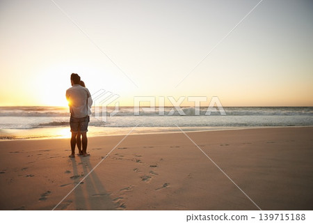 Couple, hug and beach sunset for summer travel or adventure, bonding or marriage. People, love and embrace at ocean water for dating tourism or back view for nature vacation, mockup or holiday Couple, hug and beach sunset for summer travel or adventure, bonding or marriage. People, love and embrace at ocean water for dating tourism or back view for nature vacation, mockup or holiday 139715188