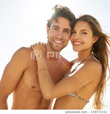Couple, happy and holiday portrait with hug, love and care together in the sunshine on vacation outdoor. Relax, smile and date by a beach with summer travel with romance and lens flare on a trip Couple, happy and holiday portrait with hug, love and care together in the sunshine on vacation outdoor. Relax, smile and date by a beach with summer travel with romance and lens flare on a trip 139715211