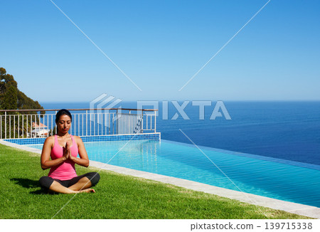 Meditation, yoga and woman on grass by pool for holistic fitness, mindfulness and breathing exercise. Summer, hands in prayer and person by ocean for wellness, health and zen energy outdoors Meditation, yoga and woman on grass by pool for holistic fitness, mindfulness and breathing exercise. Summer, hands in prayer and person by ocean for wellness, health and zen energy outdoors 139715338