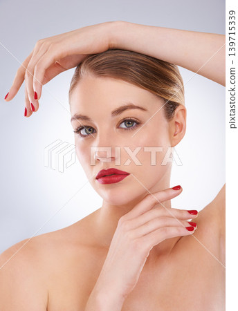 Woman, portrait and skincare in studio with red lipstick for cosmetics, beauty and aesthetic with nail polish. Model, person and confidence with makeup, glowing face and wellness on white background Woman, portrait and skincare in studio with red lipstick for cosmetics, beauty and aesthetic with nail polish. Model, person and confidence with makeup, glowing face and wellness on white background 139715339