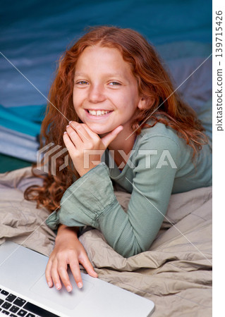 Child, relax and portrait with laptop in bed with happiness to play online games for holiday or vacation. Kid, smile and scroll on computer website, streaming movie or elearning with internet Child, relax and portrait with laptop in bed with happiness to play online games for holiday or vacation. Kid, smile and scroll on computer website, streaming movie or elearning with internet 139715426