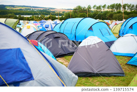 Tents, field and music festival outdoor for camp event in forest for party celebration, rave weekend on vacation. Shelter, land for crowd concert or dj disco accommodation, park trip in woods nature Tents, field and music festival outdoor for camp event in forest for party celebration, rave weekend on vacation. Shelter, land for crowd concert or dj disco accommodation, park trip in woods nature 139715574