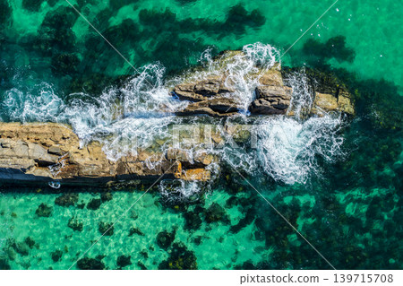 Aerial view of The Tanks in Forster NSW Australia showing rugged rock formations and turquoise water along the coastline. Drone photograph captures the natural coastal landscape Aerial view of The Tanks in Forster NSW Australia showing rugged rock formations and turquoise water along the coastline. Drone photograph captures the natural coastal landscape 139715708