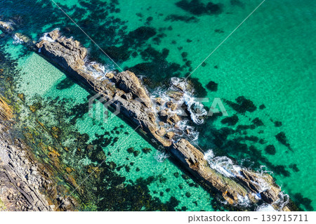Aerial view of The Tanks in Forster NSW Australia showing rugged rock formations and turquoise water along the coastline. Drone photograph captures the natural coastal landscape Aerial view of The Tanks in Forster NSW Australia showing rugged rock formations and turquoise water along the coastline. Drone photograph captures the natural coastal landscape 139715711
