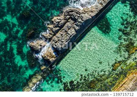 Aerial view of The Tanks in Forster NSW Australia showing rugged rock formations and turquoise water along the coastline. Drone photograph captures the natural coastal landscape Aerial view of The Tanks in Forster NSW Australia showing rugged rock formations and turquoise water along the coastline. Drone photograph captures the natural coastal landscape 139715712