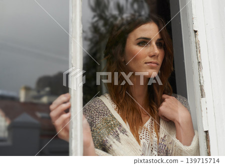 Woman, thinking and smile by window in home with waiting, wondering and daydreaming in farmhouse. Person, face and thoughtful by glass in lounge with contemplation, lonely and reflection with view Woman, thinking and smile by window in home with waiting, wondering and daydreaming in farmhouse. Person, face and thoughtful by glass in lounge with contemplation, lonely and reflection with view 139715714