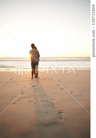 Man, woman and beach love at sunset for romantic summer travel or adventure, bonding or marriage. Couple, footprints and embrace at water for dating tourism or nature vacation, environment or holiday Man, woman and beach love at sunset for romantic summer travel or adventure, bonding or marriage. Couple, footprints and embrace at water for dating tourism or nature vacation, environment or holiday 139715804