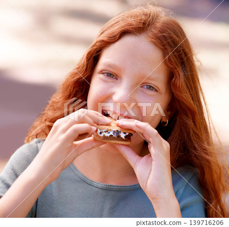 Child, eating and portrait with smores outdoor, camping and relax at barbecue with dessert or cookie. Happy, girl and hungry for biscuit with marshmallow in woods or forest on holiday or vacation Child, eating and portrait with smores outdoor, camping and relax at barbecue with dessert or cookie. Happy, girl and hungry for biscuit with marshmallow in woods or forest on holiday or vacation 139716206