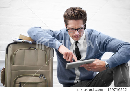 Business man, reading or baggage with tablet, floor and stress with app, flight or travel by wall background. Entrepreneur, person or touchscreen on social media, bag or check booking for immigration Business man, reading or baggage with tablet, floor and stress with app, flight or travel by wall background. Entrepreneur, person or touchscreen on social media, bag or check booking for immigration 139716222