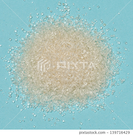 A pile of white crystal sugar on a blue background in a file A pile of white crystal sugar on a blue background in a file 139716429