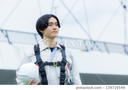 Workers wearing full body harnesses Workers wearing full body harnesses 139716549