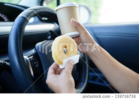 Asian woman driver hold coffee cup for drink in car. Asian woman driver hold coffee cup for drink in car. 139716738