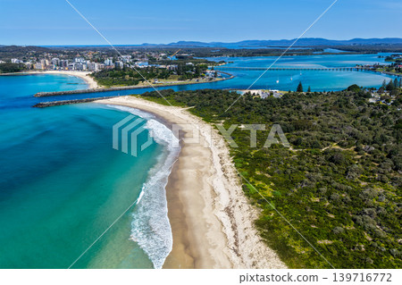 Aerial view of Nine Mile Beach and the Forster Tuncurry breakwalls in NSW Australia. Drone photograph captures the expansive sandy shoreline, ocean coastline and harbour entrance 139716772