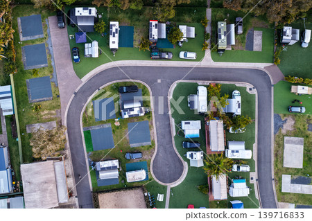 Aerial downward view of a caravan setup at a caravan park in Forster NSW Australia. Drone photograph captures caravans, camping infrastructure 139716833