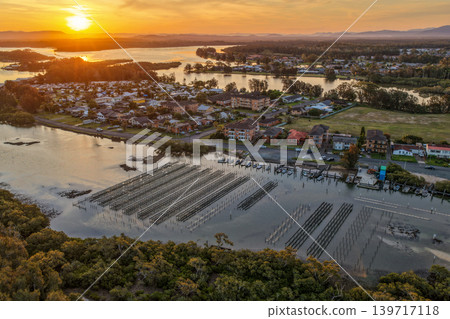 Aerial view of an oyster lease in the clear shallow waters of Wallis Lake in Forster NSW Australia. Drone photograph captures oyster farming infrastructure, transparent waterways and natural estuary 139717118