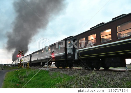 The SL Ban'etsu Monogatari train departs from Magashimo Station on the Ban'etsu West Line at dusk. The SL Ban'etsu Monogatari train departs from Magashimo Station on the Ban'etsu West Line at dusk. 139717134