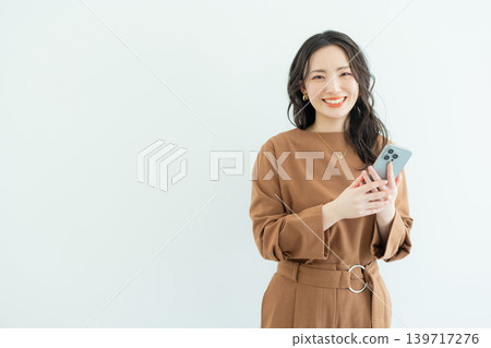 Business woman with a smartphone Business woman with a smartphone 139717276