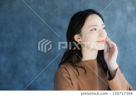 A woman smiling with a cheek A woman smiling with a cheek 139717366