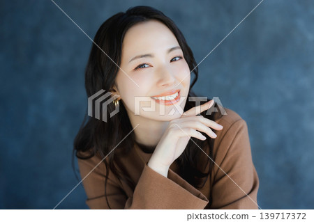 A woman smiling with a cheek 139717372