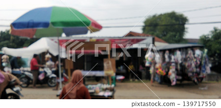 Traditional market activities with colorful umbrellas and blur effects. 139717550