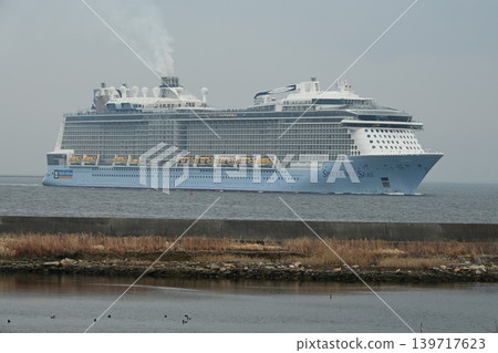 A distant view from the Osaka South Port Bird Sanctuary: The giant cruise ship Spectrum of the Seas entering Osaka Port. A distant view from the Osaka South Port Bird Sanctuary: The giant cruise ship Spectrum of the Seas entering Osaka Port. 139717623