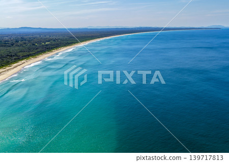 Aerial view of Nine Mile Beach in Tuncurry NSW Australia. Drone photograph captures the expansive sandy shoreline, rolling ocean waves and scenic coastal landscape 139717813