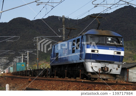 A freight train pulled by an EF210 locomotive running on the Sanyo Main Line. A freight train pulled by an EF210 locomotive running on the Sanyo Main Line. 139717984