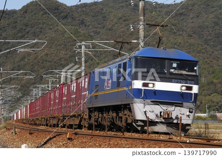 A freight train pulled by an EF210 locomotive running on the Sanyo Main Line. A freight train pulled by an EF210 locomotive running on the Sanyo Main Line. 139717990