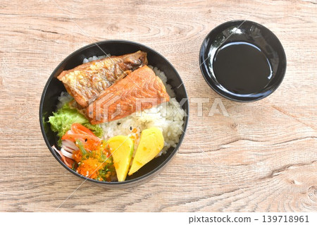 fried saba fish or mackerel on rice topping sweet egg and crab stick couple pickled seaweed topping shrimp egg salad bento set in lunch box dipping sweet black soy sauce 139718961