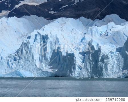 Vertical ice formations of glacier front with mountain background in Patagonia Vertical ice formations of glacier front with mountain background in Patagonia 139719068