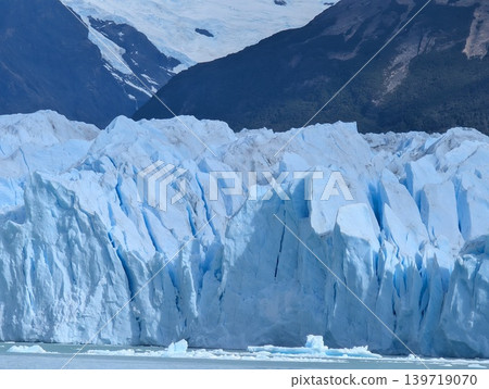 Massive blue ice blocks of glacier meeting the lake water Massive blue ice blocks of glacier meeting the lake water 139719070