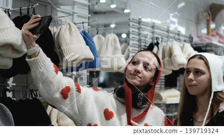 Two teenage friends are shopping for warm winter clothes. Two teenage friends are shopping for warm winter clothes. 139719324
